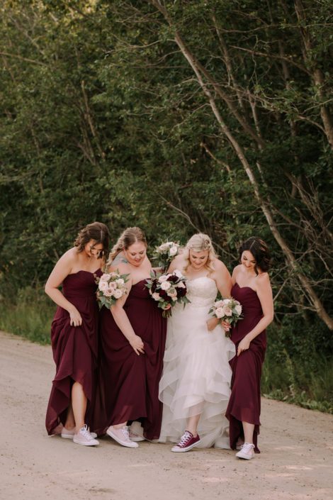 Tamara and Kyle's Rustic Chic Burgundy and Blush bride and bridesmaids with blush and burgundy bouquets and converse shoes.