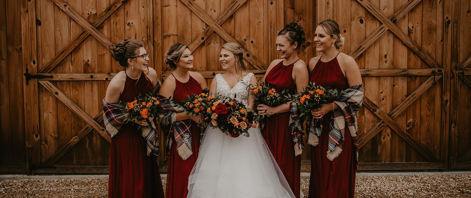 Rustic fall wedding bride, Hayley, and bridesmaids with plaid shawls and fall bridal bouquets.