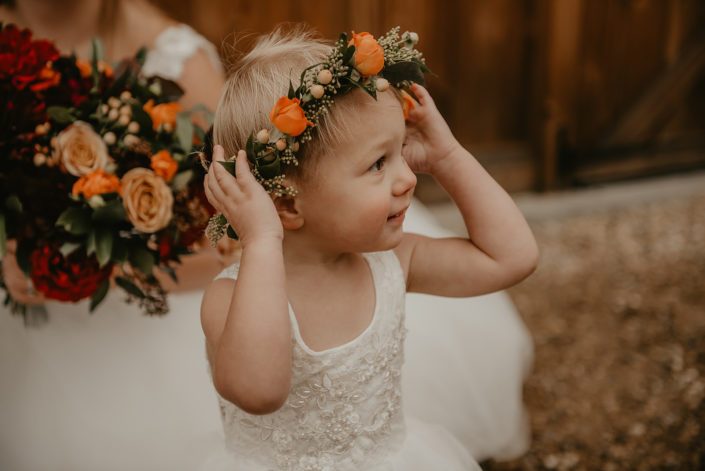 Flowergirl floral crown designed as a small delicate tie back floral crown with a mix of fall coloured blooms including solidago, hypericum berries and orange spray roses.