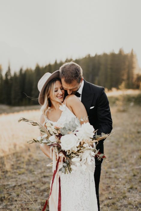 Boho bride and groom with bridal bouquet