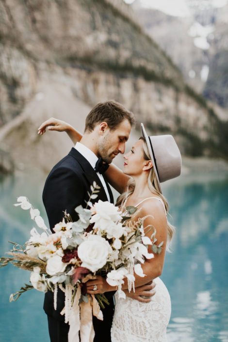 Bride and groom with boho bouquet in front of Moraine Lake