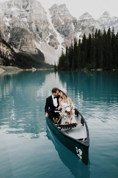 Boho bride and groom in Canoe in Rocky Mountains