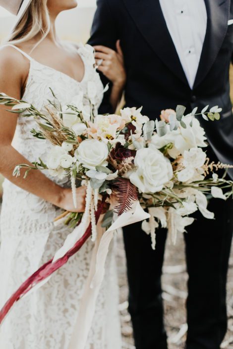 Boho Bridal Bouquet designed with olive branches, pampas grass, roses, ranunculus, lysianthus, amaranthus, astilbe, succulents, fern and sweet peas