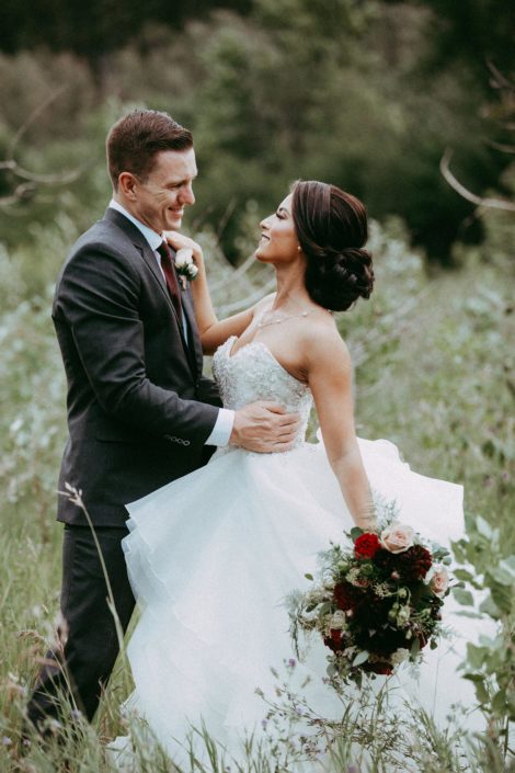 Bride and groom, Rikki Lee and Jake, with mauve and burgundy bridal bouquet