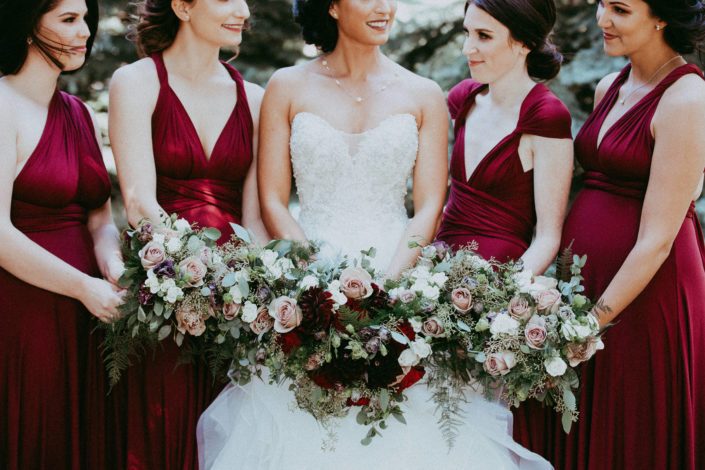 Burgundy and grey wedding bouquets designed with burgundy dahlias, hearts garden roses, black pearl lisianthus, amnesia roses, ivory spray roses, plumosa and eucalyptus