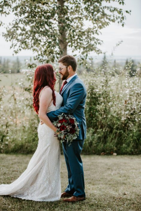 Hailey and Brandon with burgundy and royal blue bridal bouquet