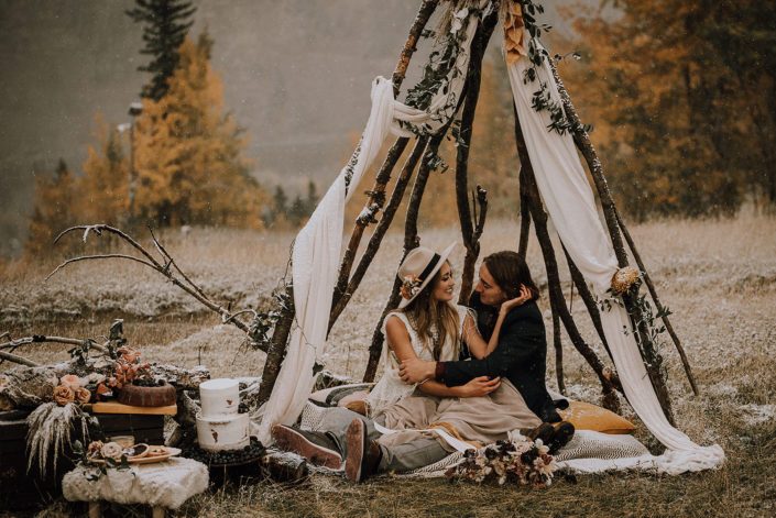 Couple sitting in a tee pee for down the aisle fall styled shoot