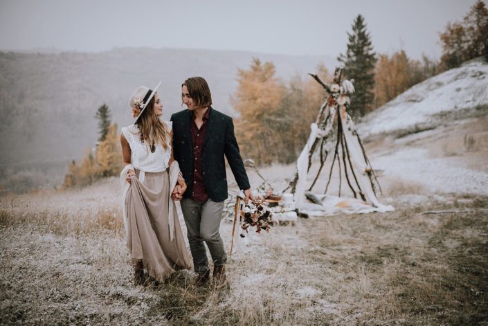 Couple walking near a tee pee for a neutral fall styled shoot