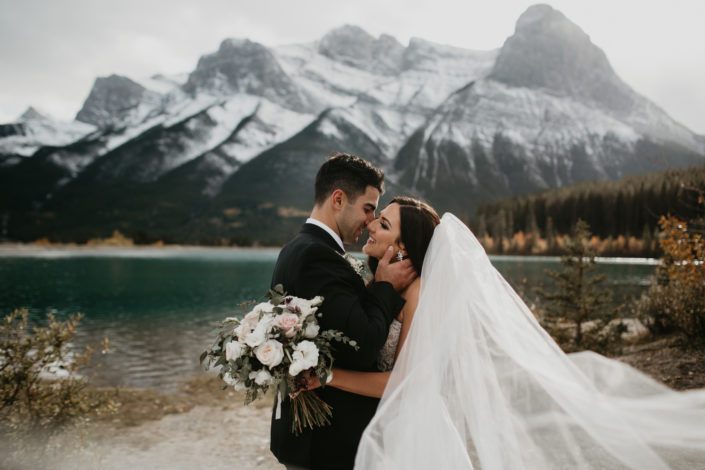 Brittany and Briggs with blush and ivory bridal bouquet in front of the Canmore mountains