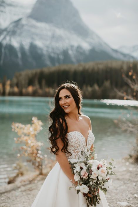 Brittany's elegant Canmore wedding bridal bouquet designed with white o'hara garden roses, quicksand roses, lisianthus, ranunculus, astrantia and gunni and seeded eucalyptus