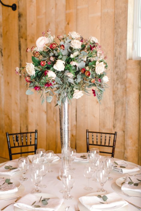 Blush and Burgundy Winter Photoshoot centrepiece arrangement designed on a tall vase