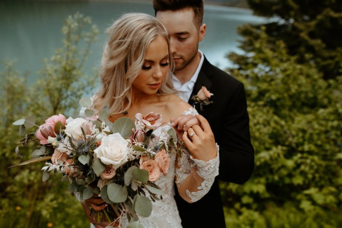 Bride and groom with blush pink and white boutonniere and bouquet designed with roses, tulips, peonies, eryngium, bleached italian ruscus and eucalyptus greenery