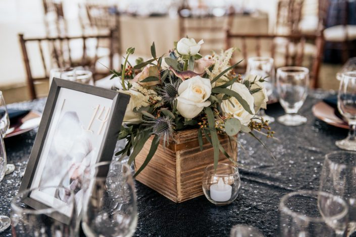 Mauve and Navy Centrepieces designed with white astilbe, eryngium, white o'hara garden roses, amnesia roses, playa blanca roses and eucalyptus in a wooden box