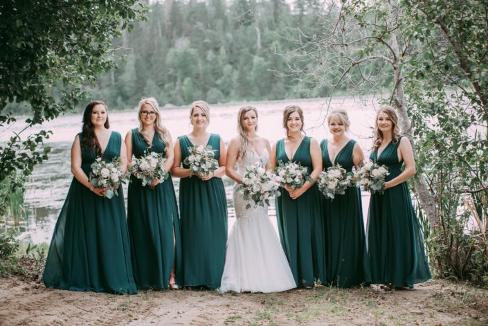 Kylie and her bridesmaids carrying white bouquets made of astilbe, roses, ranunculus, sweet peas and eucalyptus