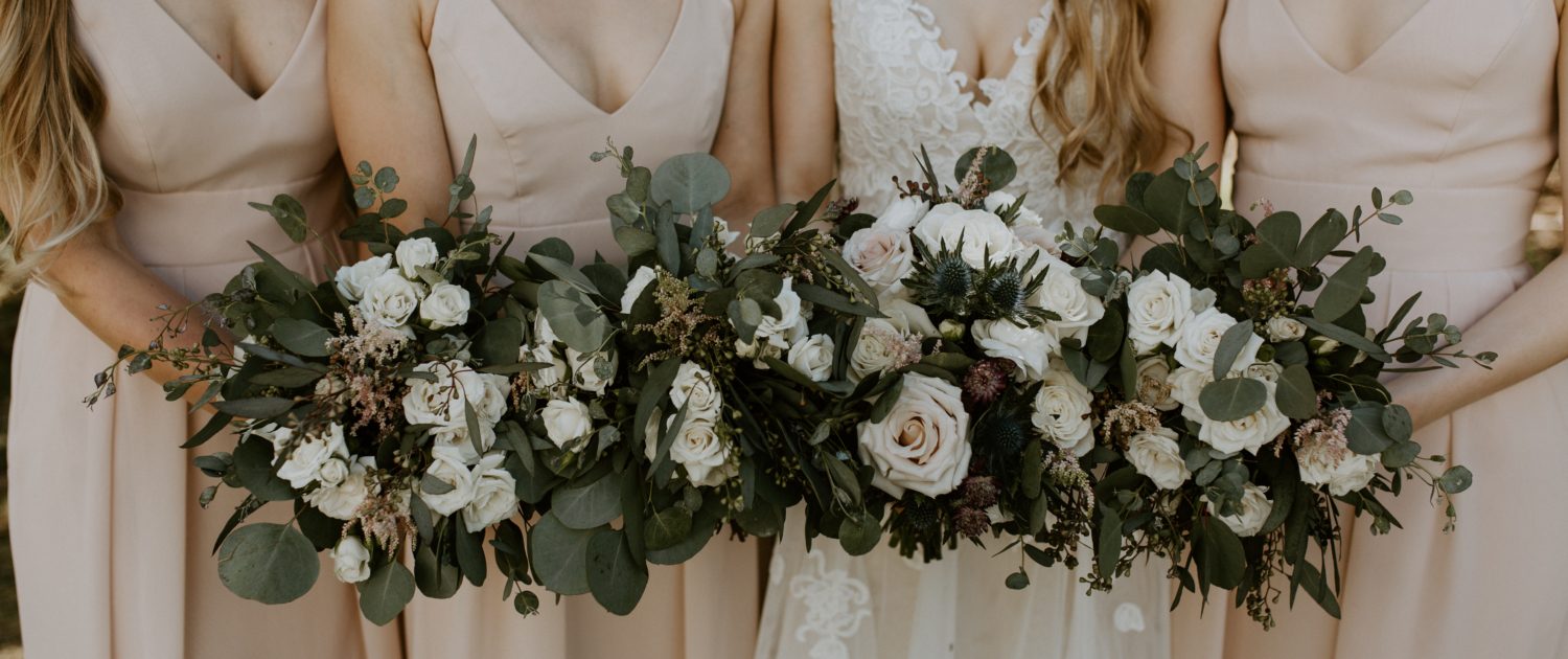 Blush bridesmaids, lace bridal gown and blush, white & burgundy bouquets designed with quicksand roses, playa blanca roses, ranunculus, erygium, astrantia, astilbe and eucalyptus