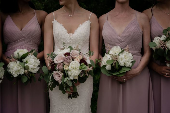 Bridal bouquet and bridesmaids bouquets; bridal bouquet featured burgundy dahlias, quicksand roses, white ranunculus, white peony, amnesia roses, pink astilbe and eucalyptus; bridesmaids bouquets designed with peonies and astilbe with eucalyptus.