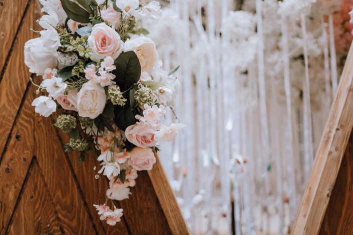 White, peach and pink permanent botanicals on a wooden backdrop