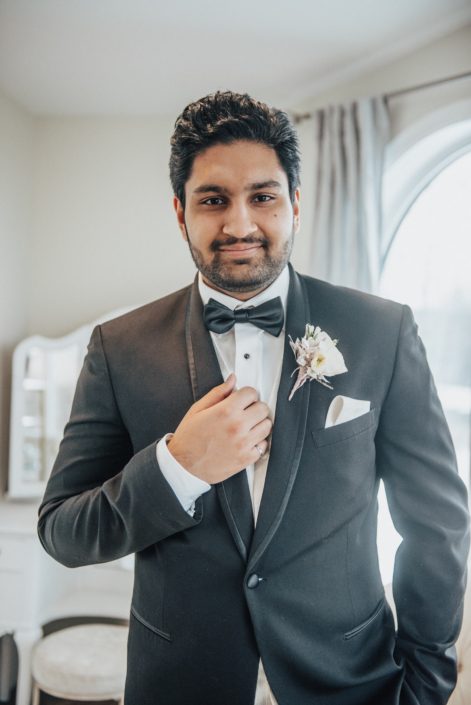 Groom in tuxedo with blush boutonniere