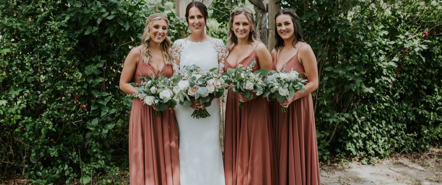 Rusty rose wedding - Bride with bridesmaids wearing rusty rose dresses