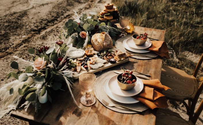 Boho sweetheart table with charcuterie and donuts