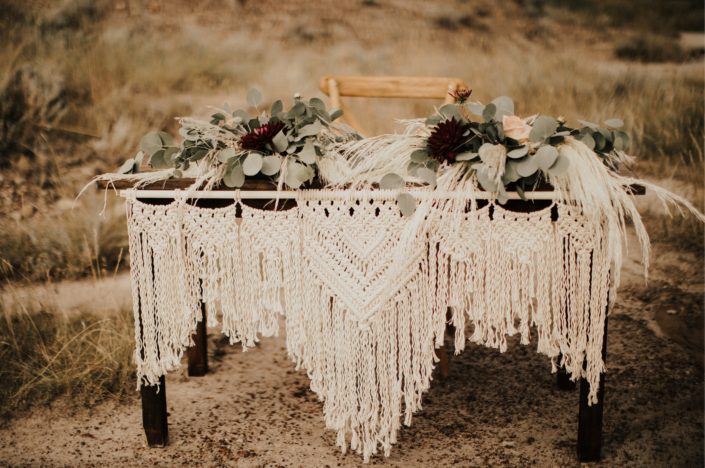 Macrame and flowers cover sweetheart table