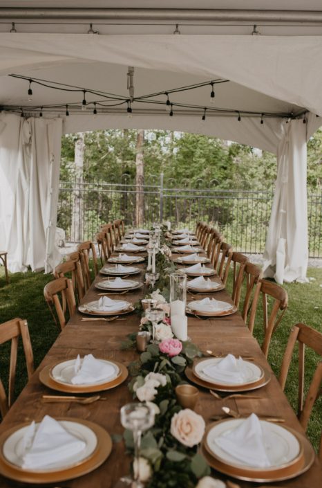 Intimate pastel wedding tent and long table with garland centrepiece