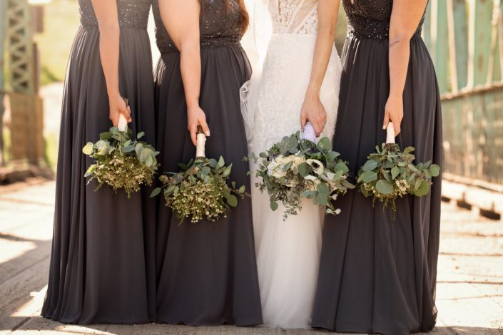 Bride and bridesmaids with bouquets facing down