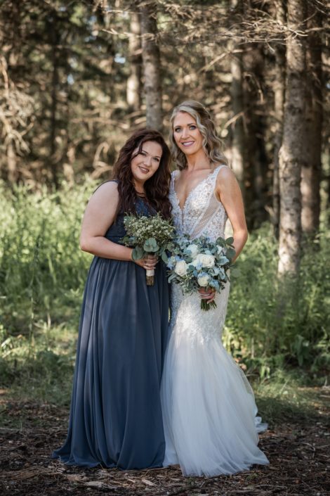 Bride with bridesmaid and bouquets made of greenery and flowers