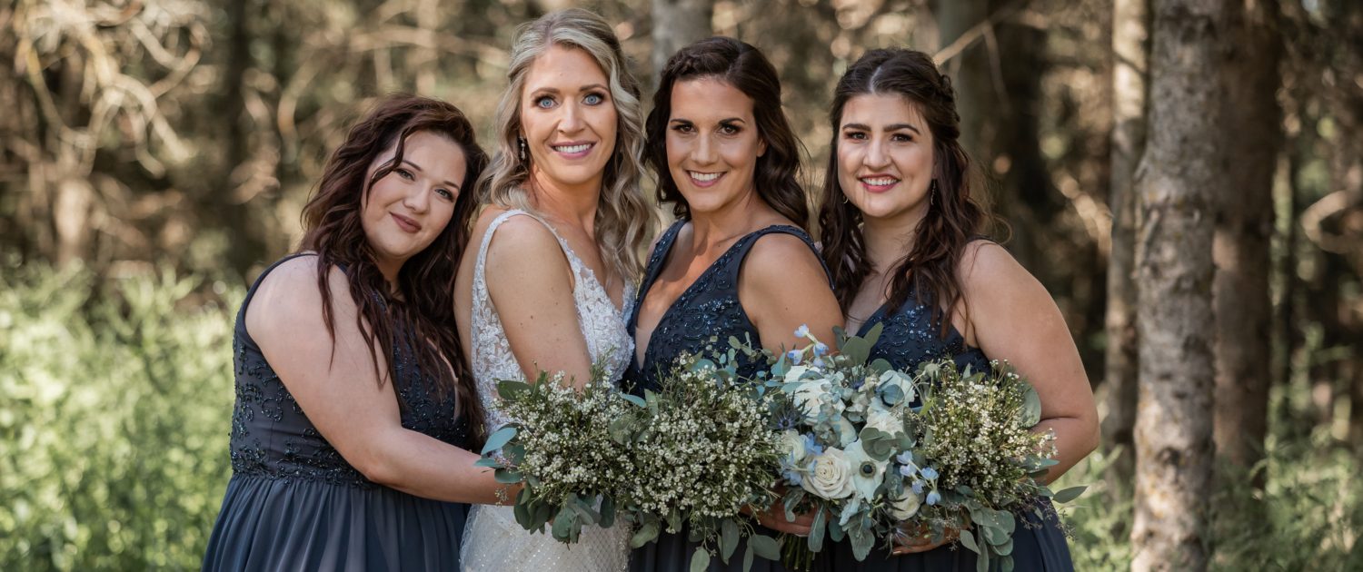 Bride and bridesmaids with bouquets clustered together