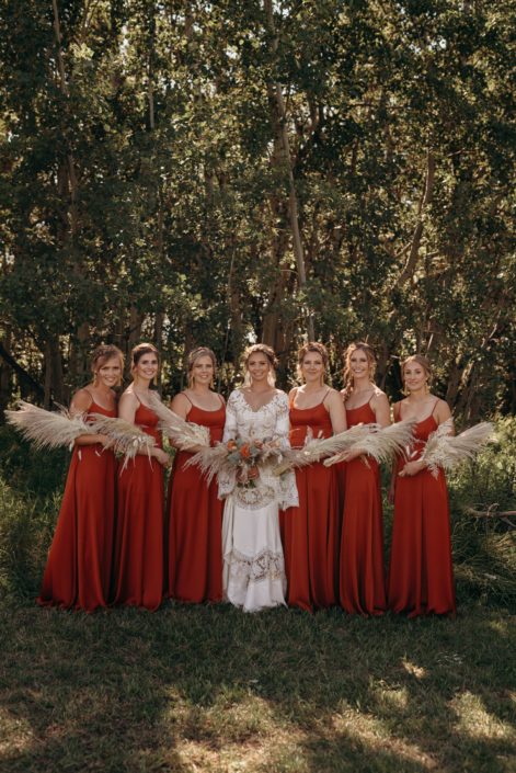 Bride and orange bridesmaids; boho bouquets made of pampas grass, bleached bracken fern, bunny tails and orange flowers