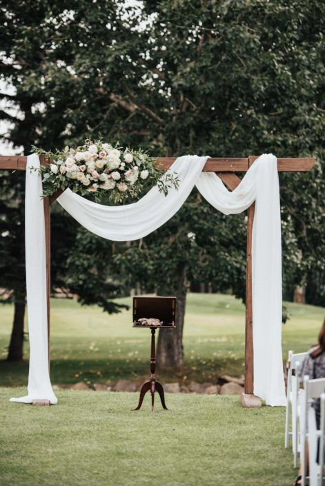Wedding archway with white draping and flowers
