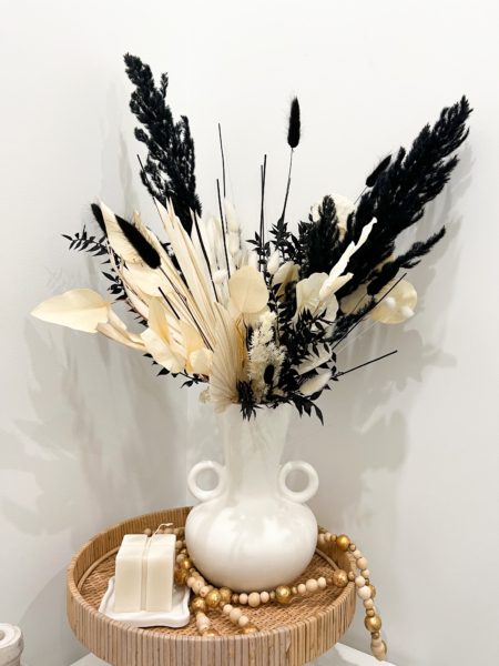 Black and bleached dried arrangement in modern vase