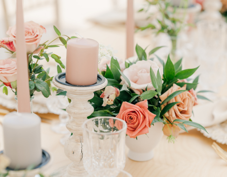 Short beautiful blush, peach and pink flower arrangement on event tables