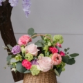 Bella's basket is a woven basket filled with a bright mix of spring flowers