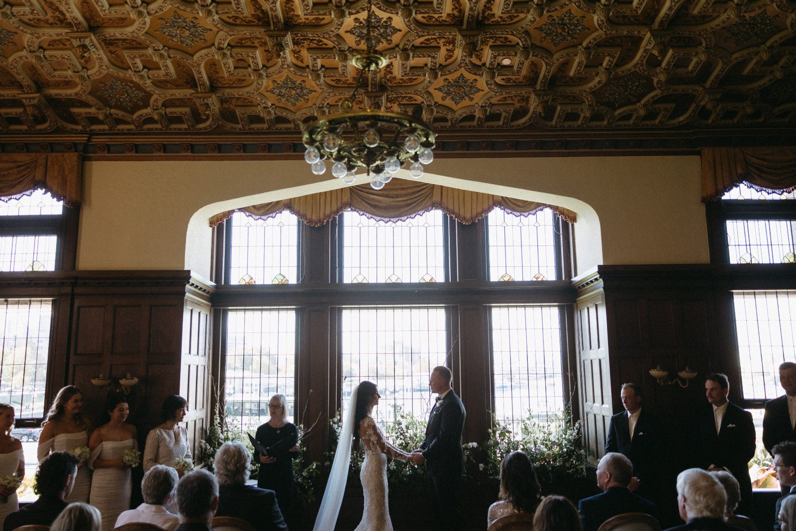 Another capture from the ceremony, zoomed out to capture all of the bridal party, some of the guests as well as some of the beautiful details of the library at the Fairmont Empress.