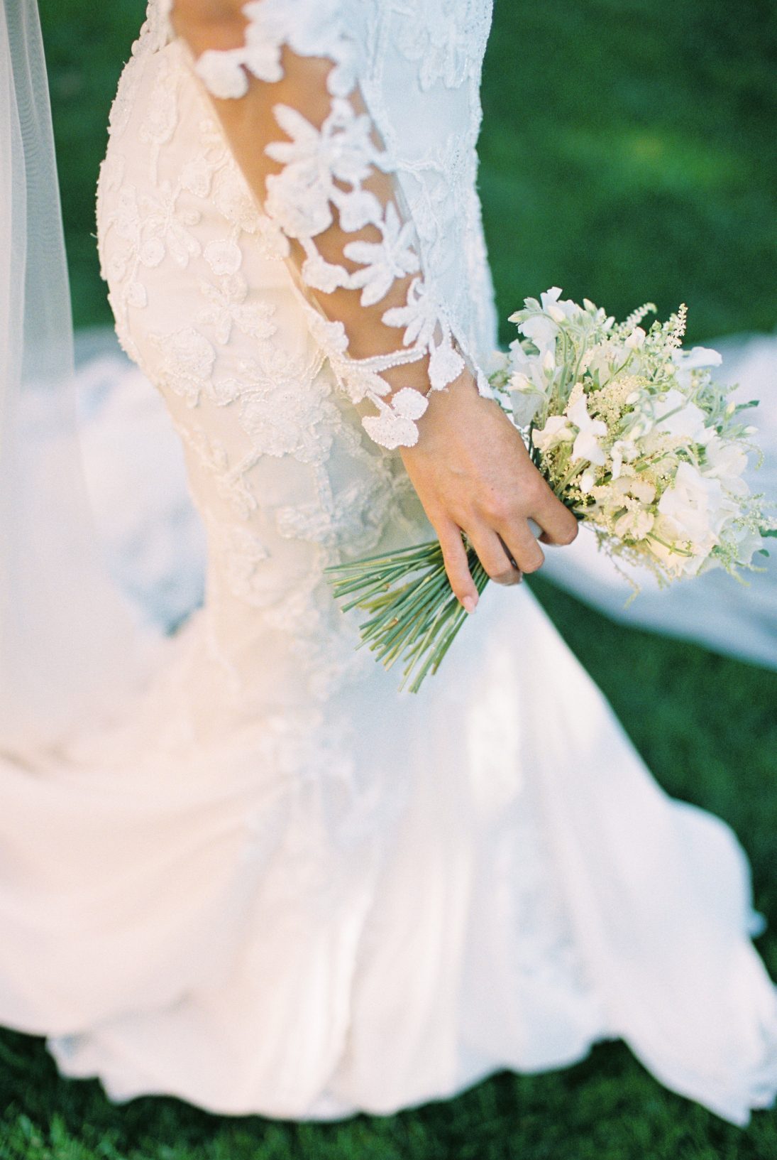 A close up of Stephanie's beautiful white posy bouquet, rich in texture with delicate blooms