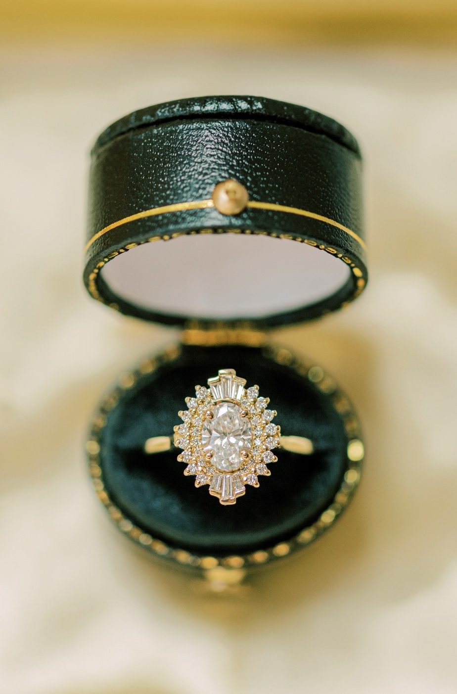 A close up detail shot of the beautiful wedding ring in a dark, decorative jewelry box