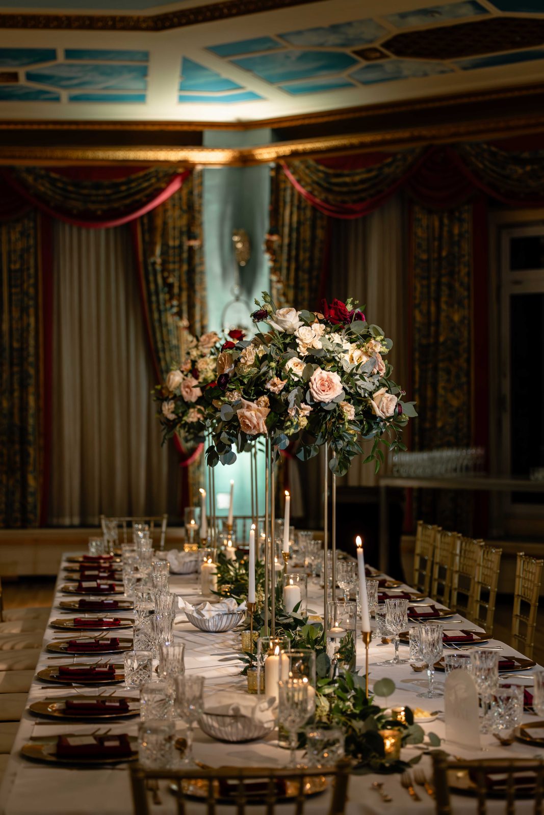 Elegant tall centrepieces featuring burgundy, blush and ivory blooms for a classic romantic look