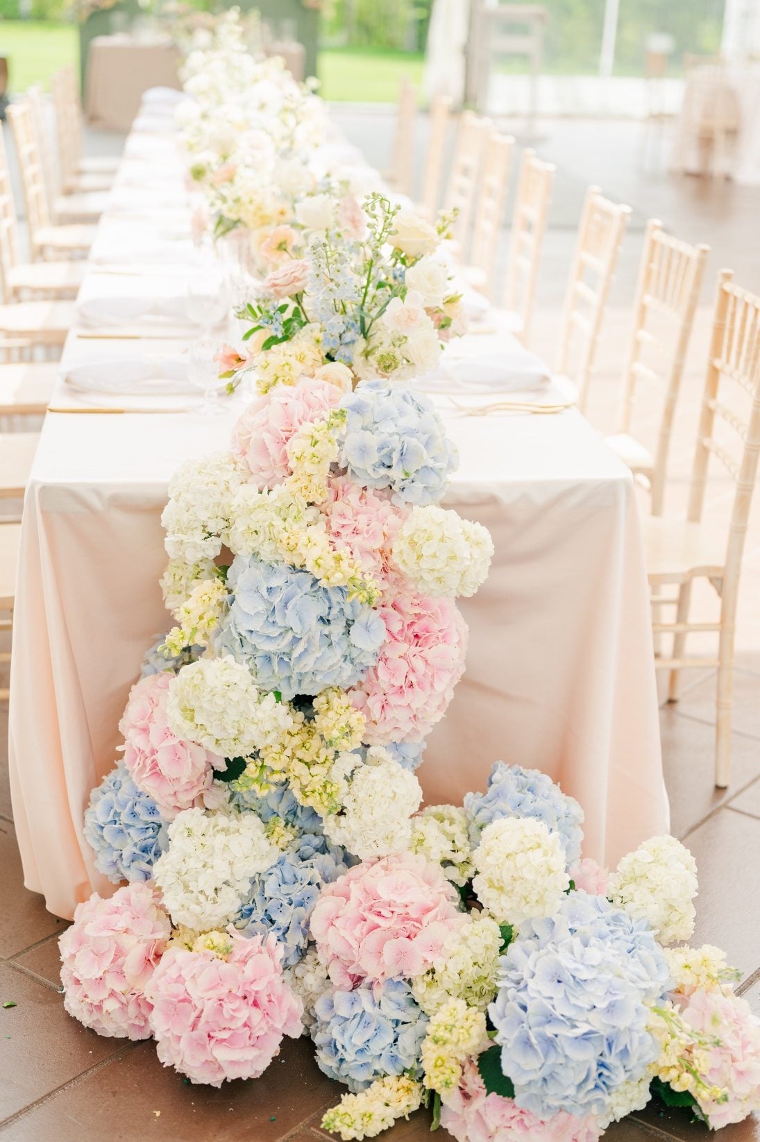 A close up of the beautiful hydrangea cascade off the front of the long table.