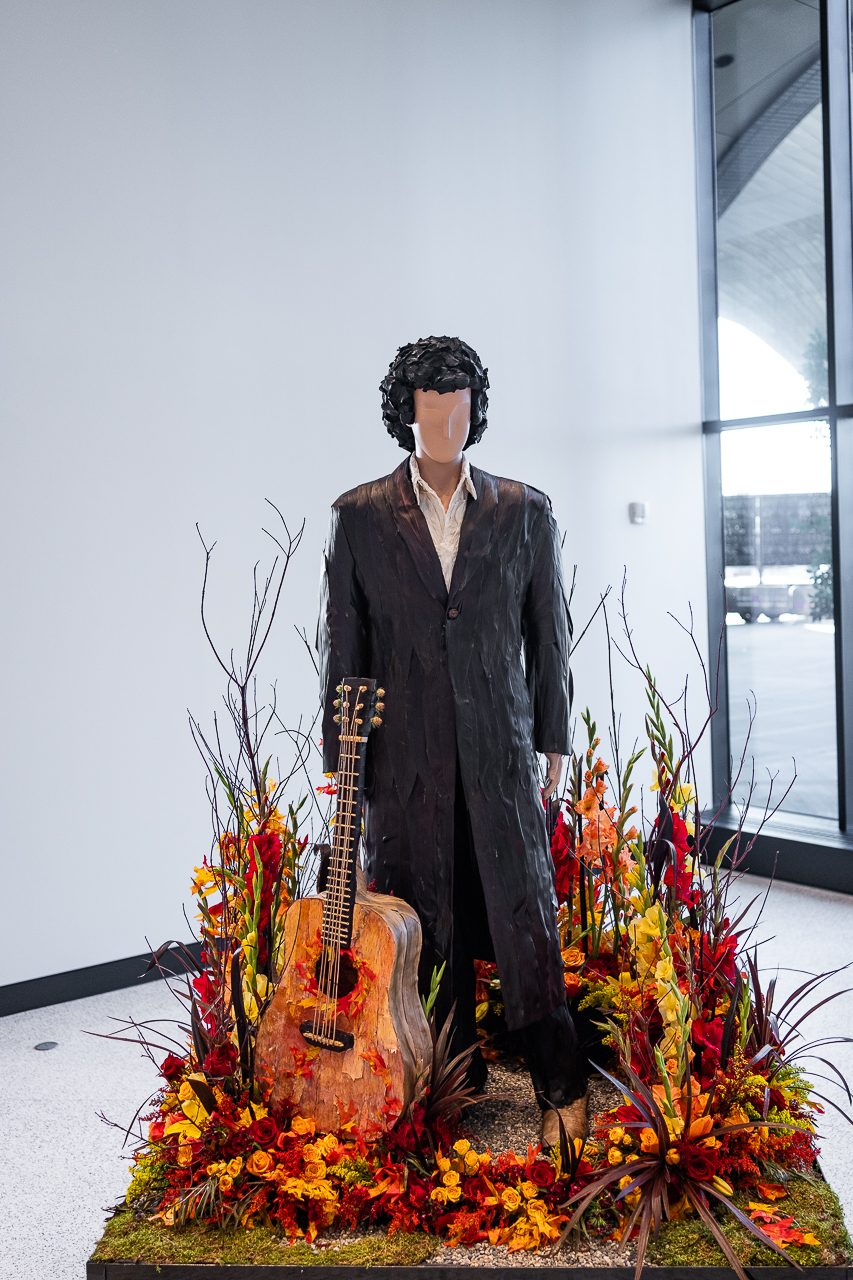 Johnny Cash inspired by "Ring of Fire" with reds, oranges and yellows with a beautifully made suit of black leaves, a very realistic guitar.