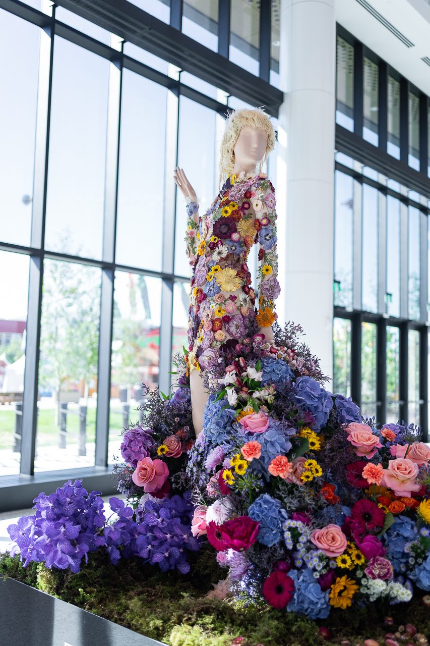 Taylor swift, with a beautiful bodice of dried flowers and a full, billowing skirt of fresh flowers.