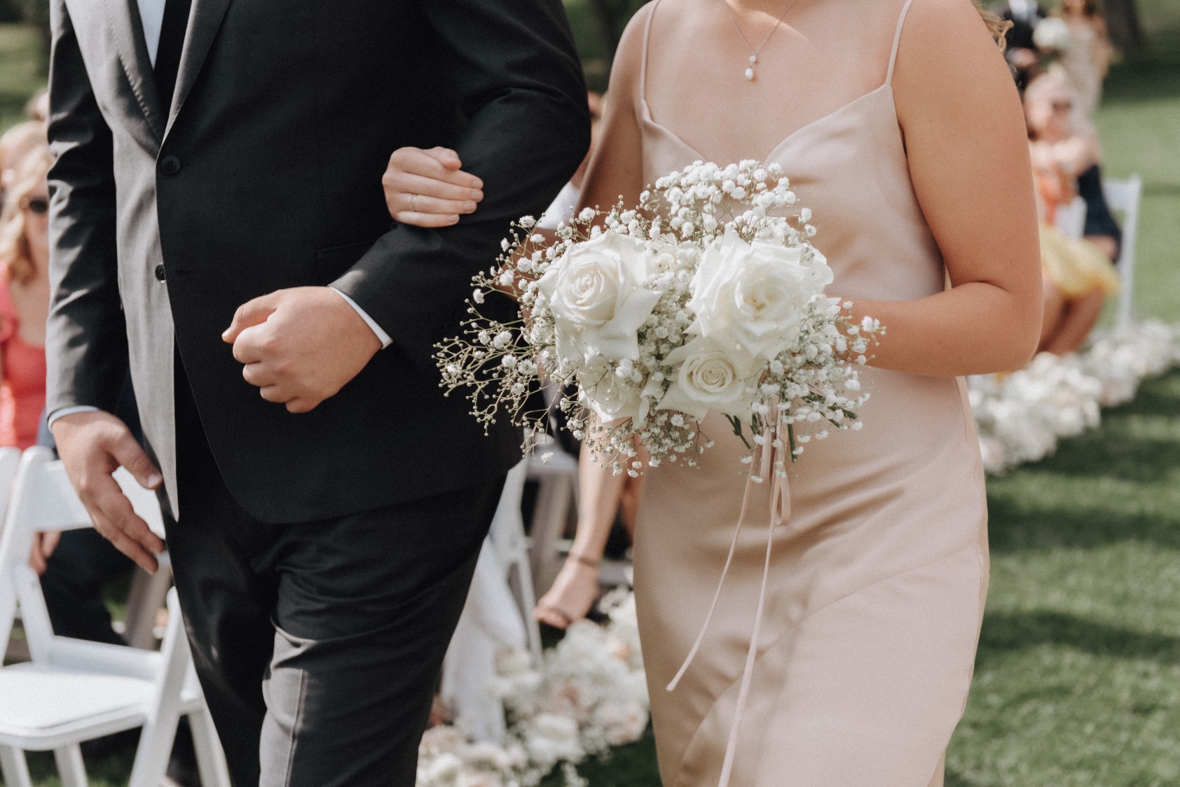 Bridesmaid Bouquet Another one of Tianna's bridesmaid with a beautiful champagne gown, holding her bouquet in one hand and the other holding on to the groomsman's arm as they walk down the aisle