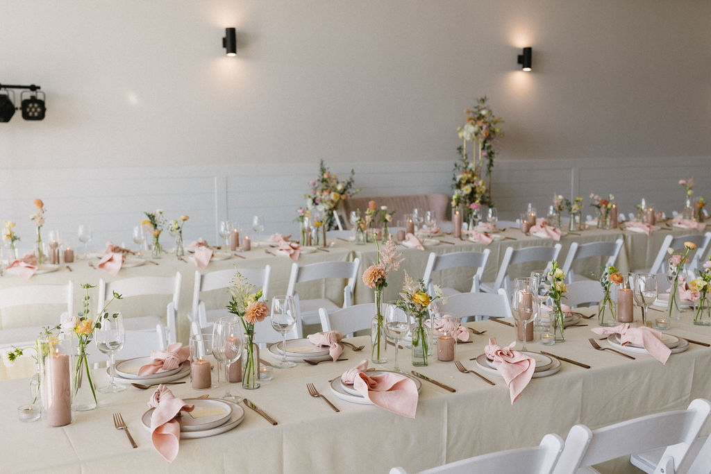 All the bud vase centrepieces with the seating area displayed in the background.