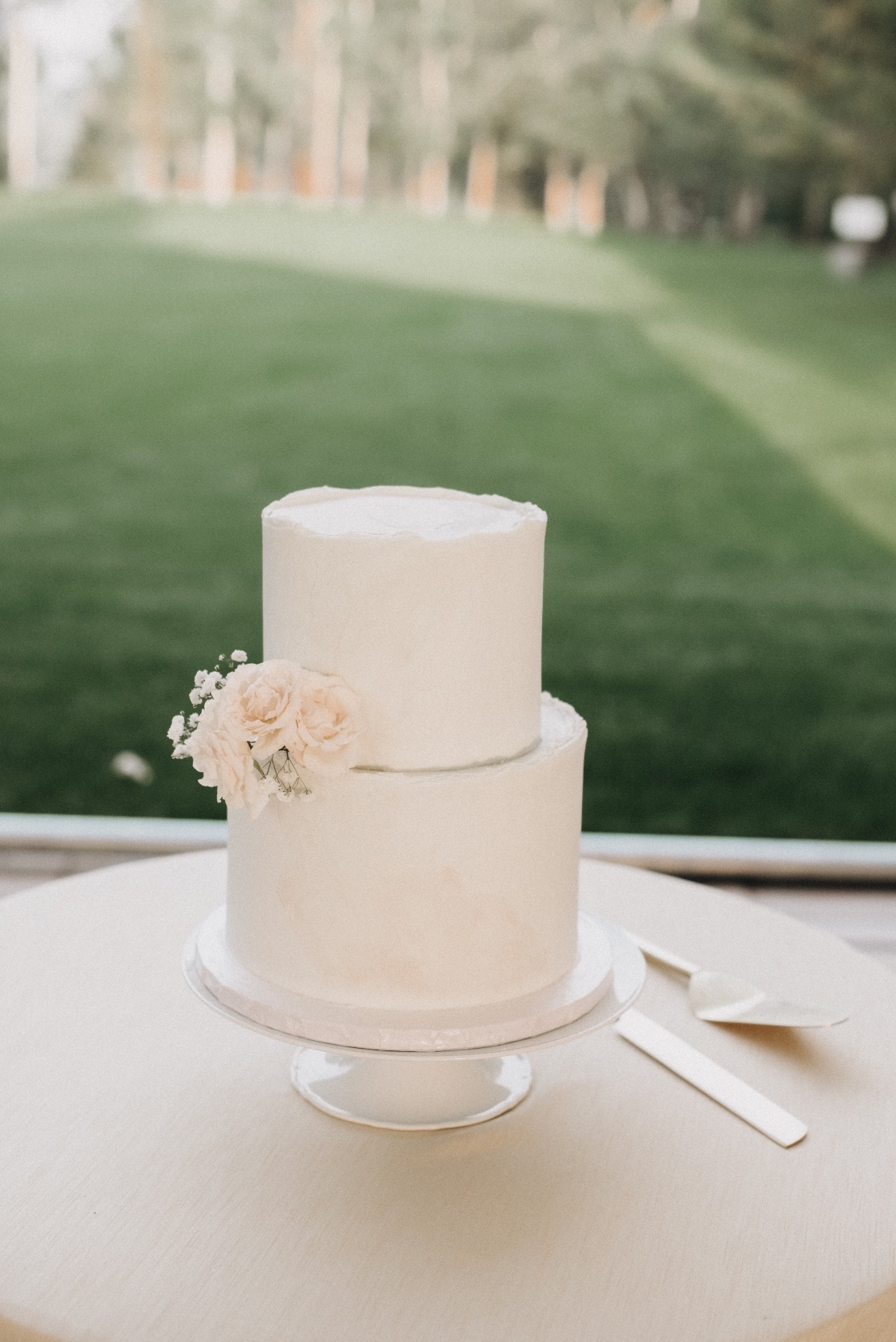 Cake Close up of the elegant cake with a perfect little cake corsage sitting on top of the lower tier.