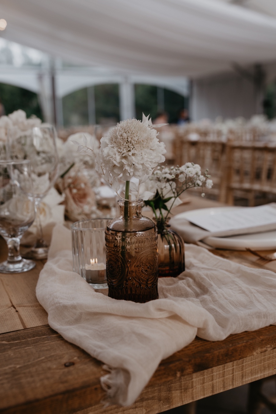Centrepiece Another cluster of bud vases at the end of a longer table, showcasing a beautiful white scabiosa bloom.