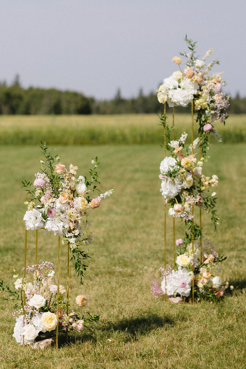 Spectacular floral stands at the end of the aisle full of white, pink and peach gardeny blooms.