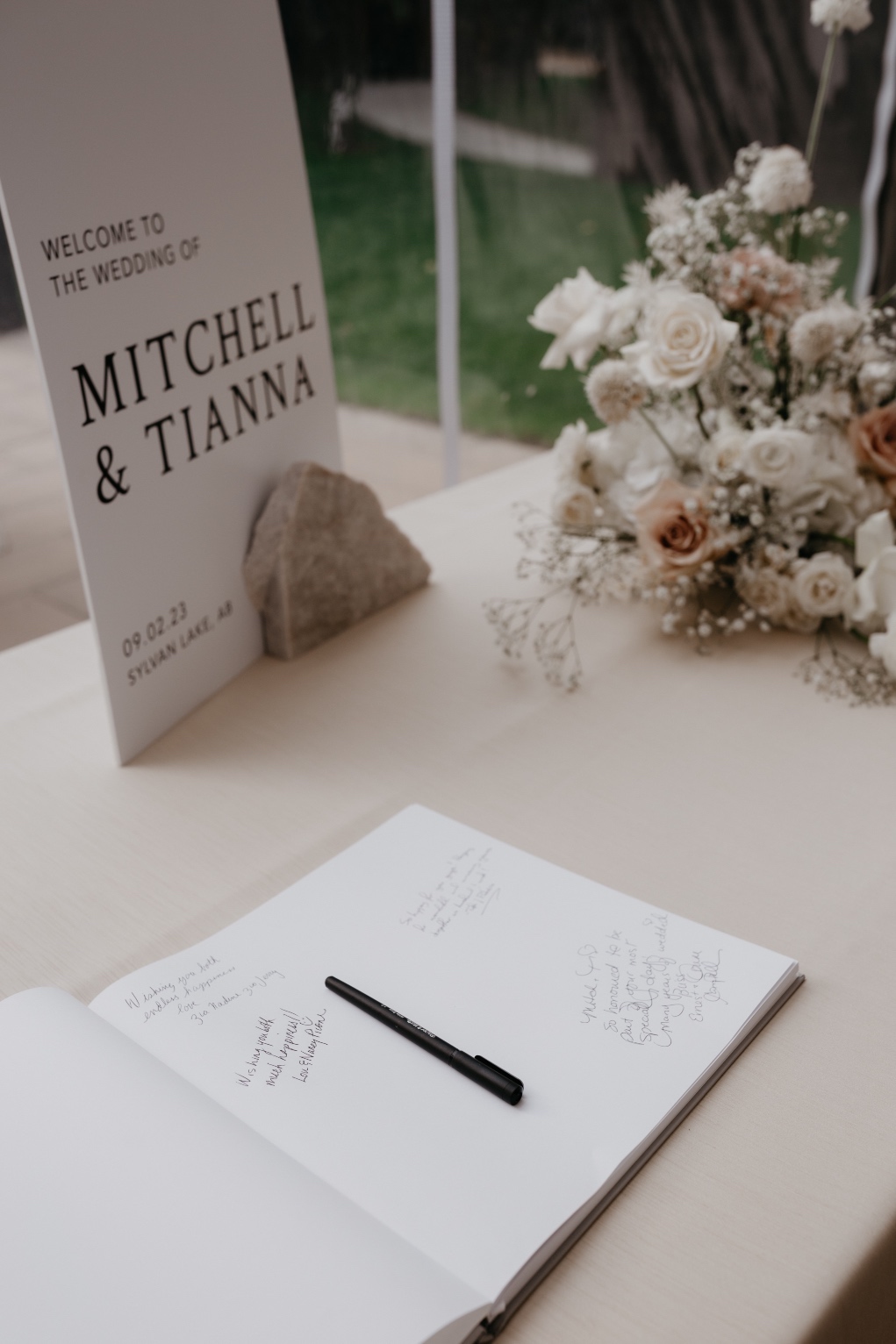 Guest Book The guest book table with the couples welcoming sign, and one of the arrangements that had been use on the white pillars at the ceremony.