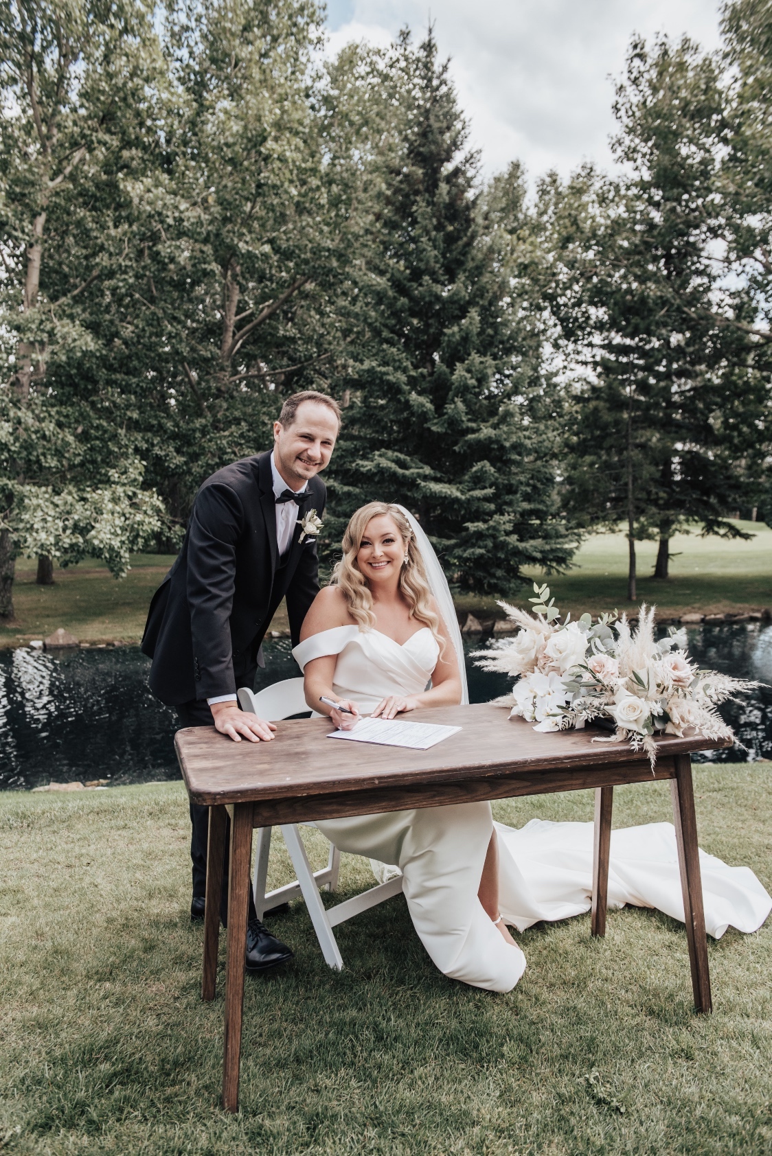 The beautiful couple, Holly + Scott, make it official at the signing table