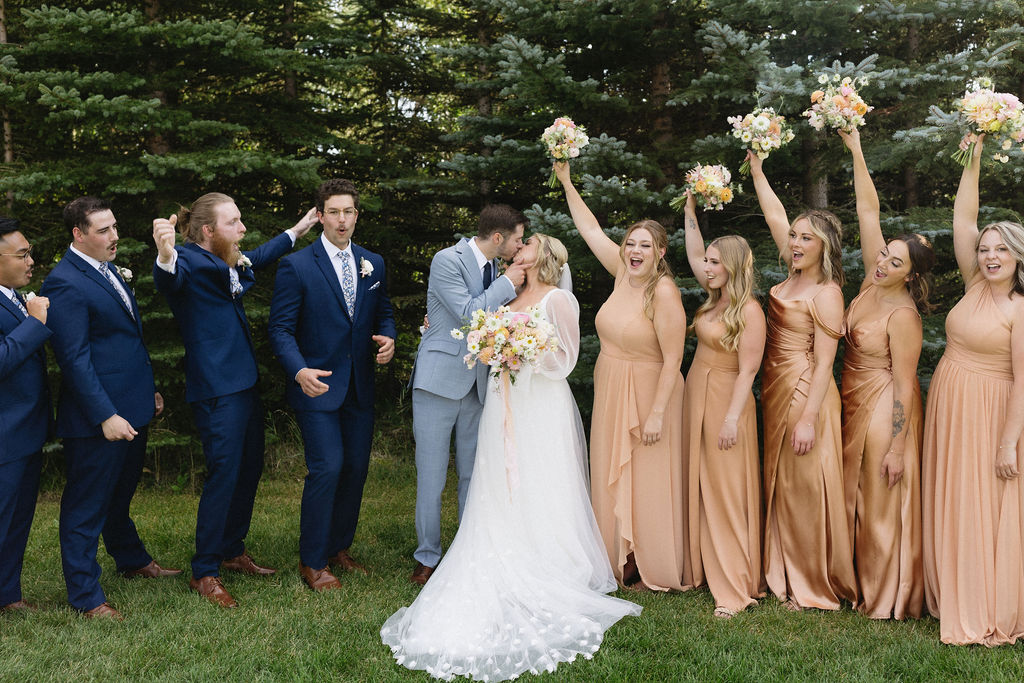 McKinley and Eric smooching with their bridal party celebrating.