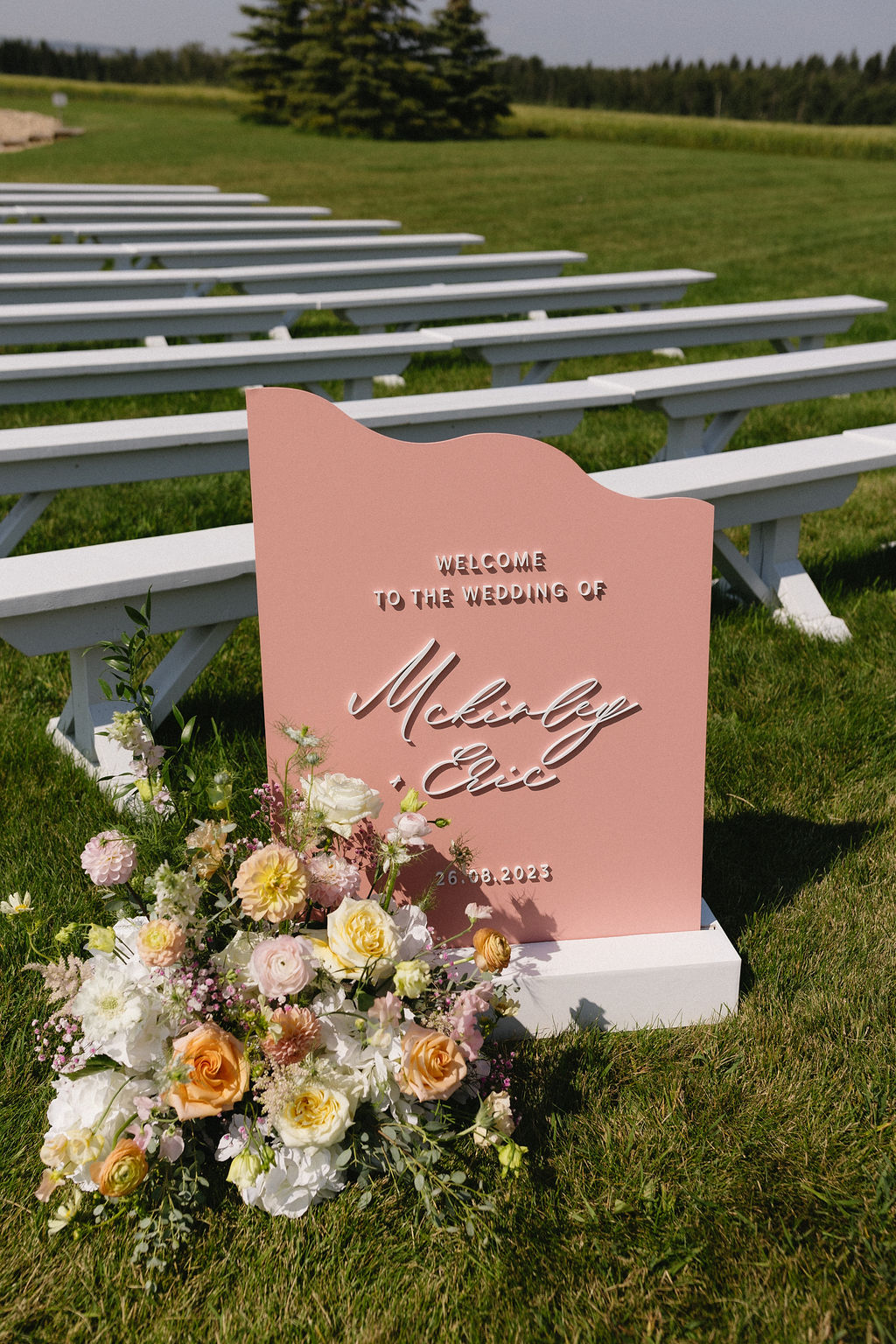 Big, pretty arrangement to accent the welcoming sign at the start of the aisle.